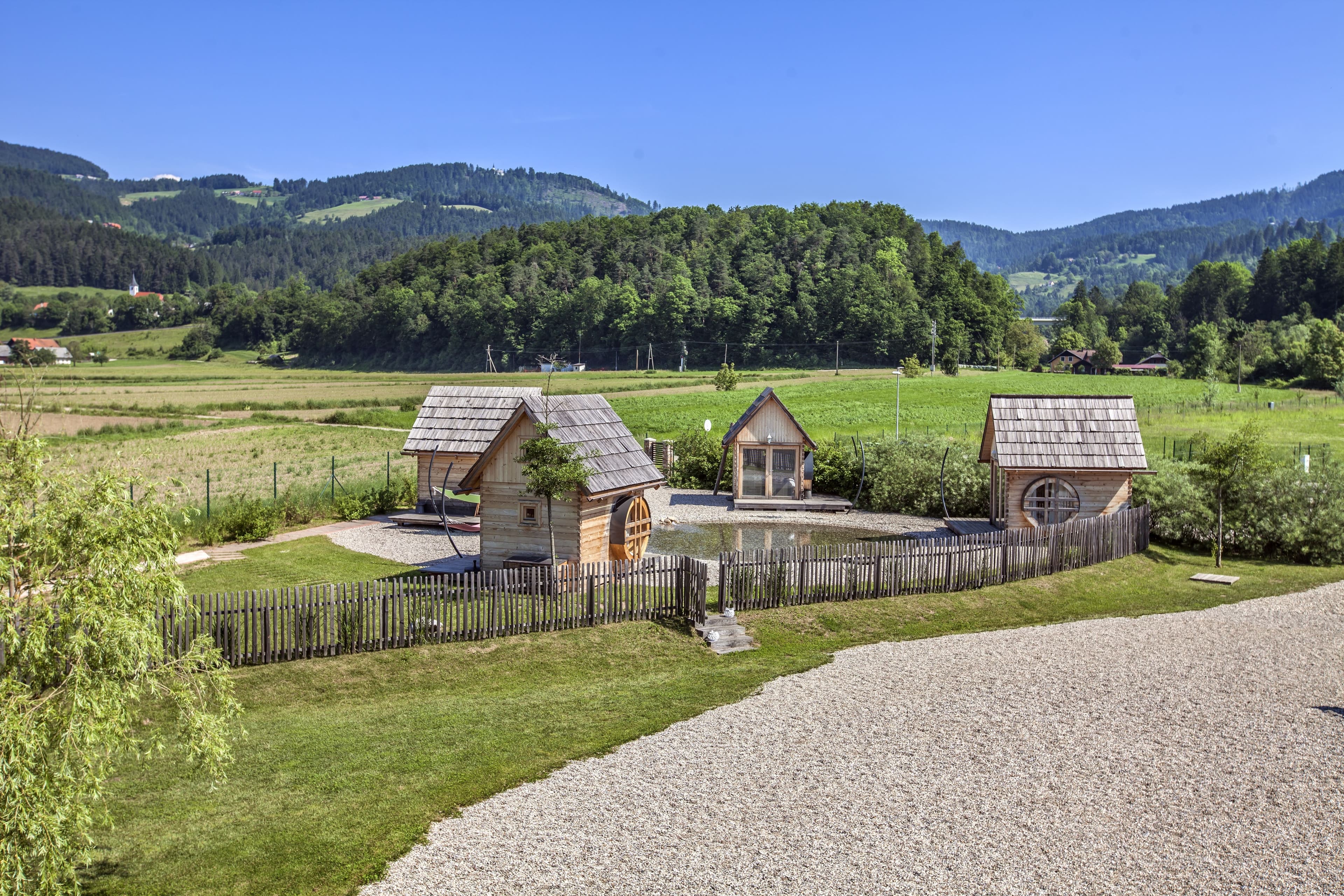 high-angle-shot-small-wooden-houses-countryside-slovenia.jpg