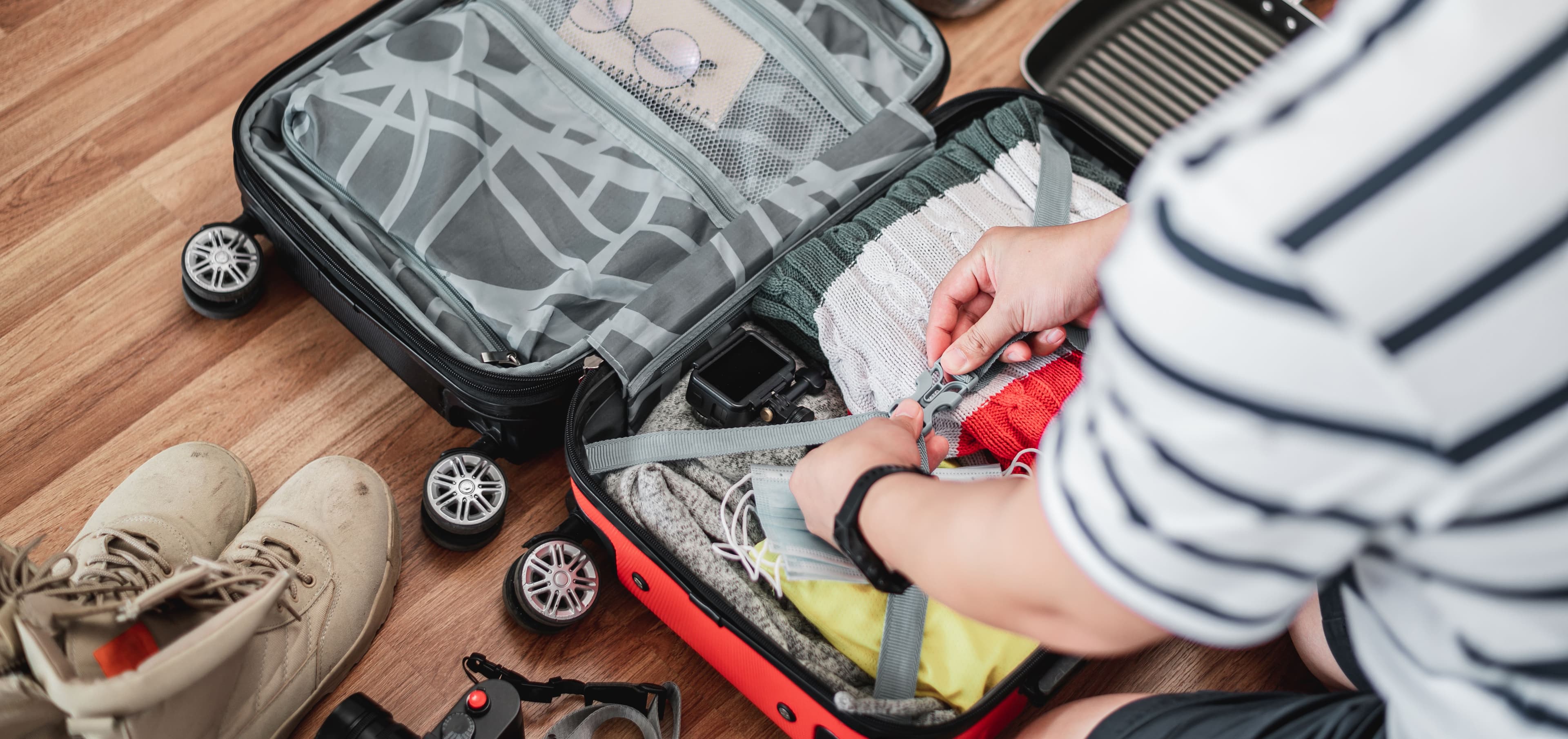 preparing-suitcase-summer-vacation-trip-young-man-checking-accessories-stuff-luggage-travel-holiday-vacation-concept.jpg