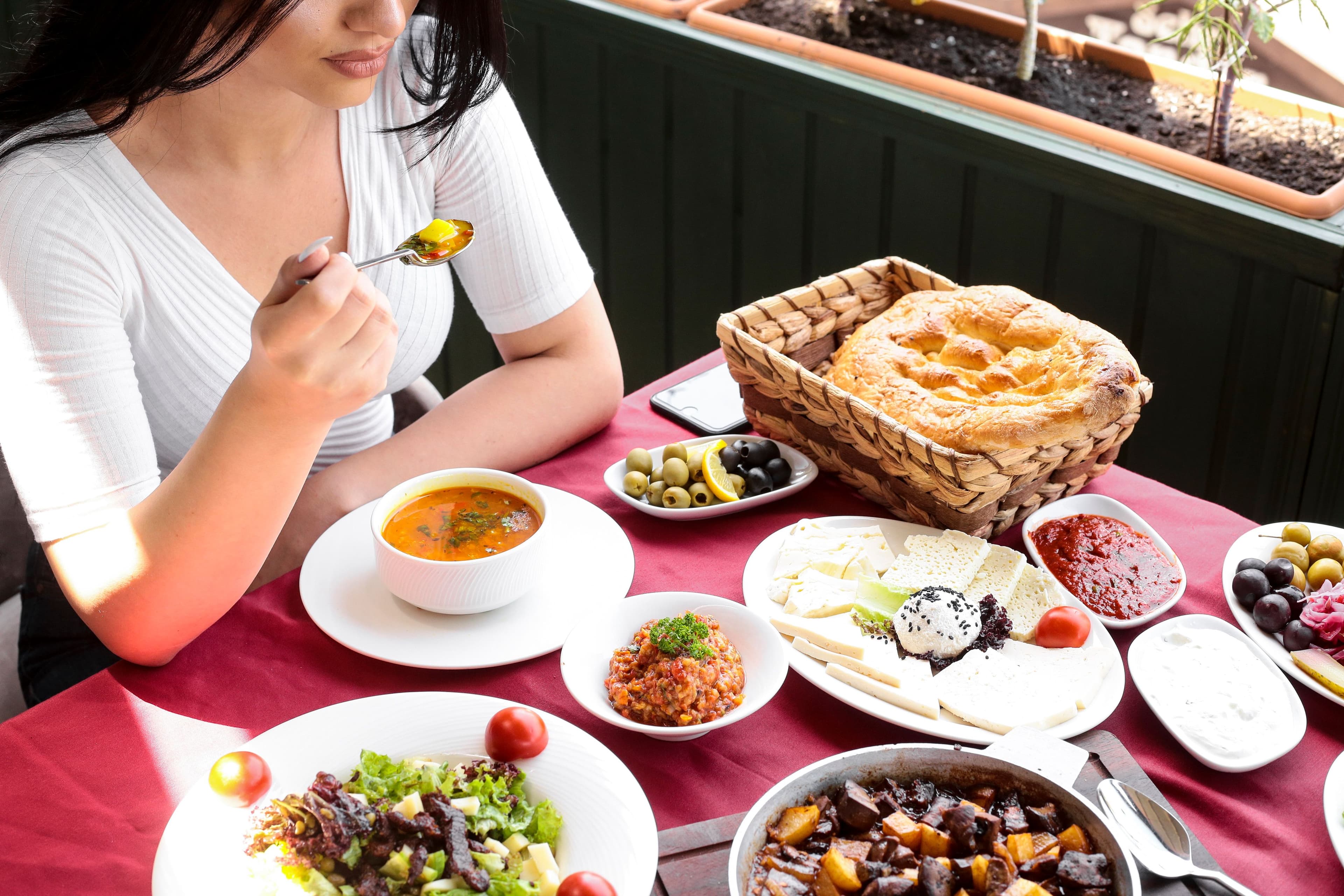 top-view-woman-eats-chicken-soup-with-salads-cheese.jpg