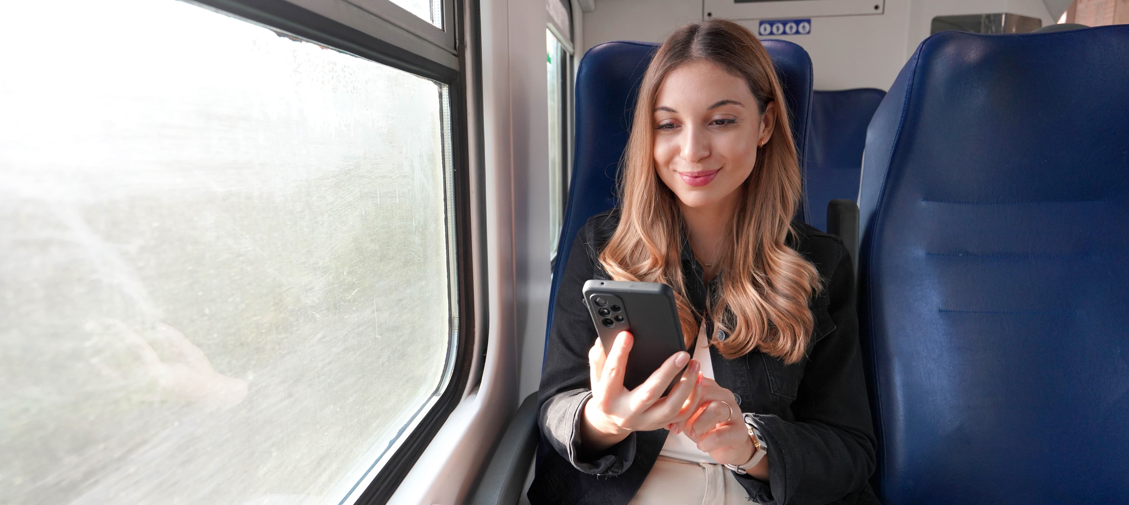 train-female-passenger-using-mobile-phone-travel-commute.jpg