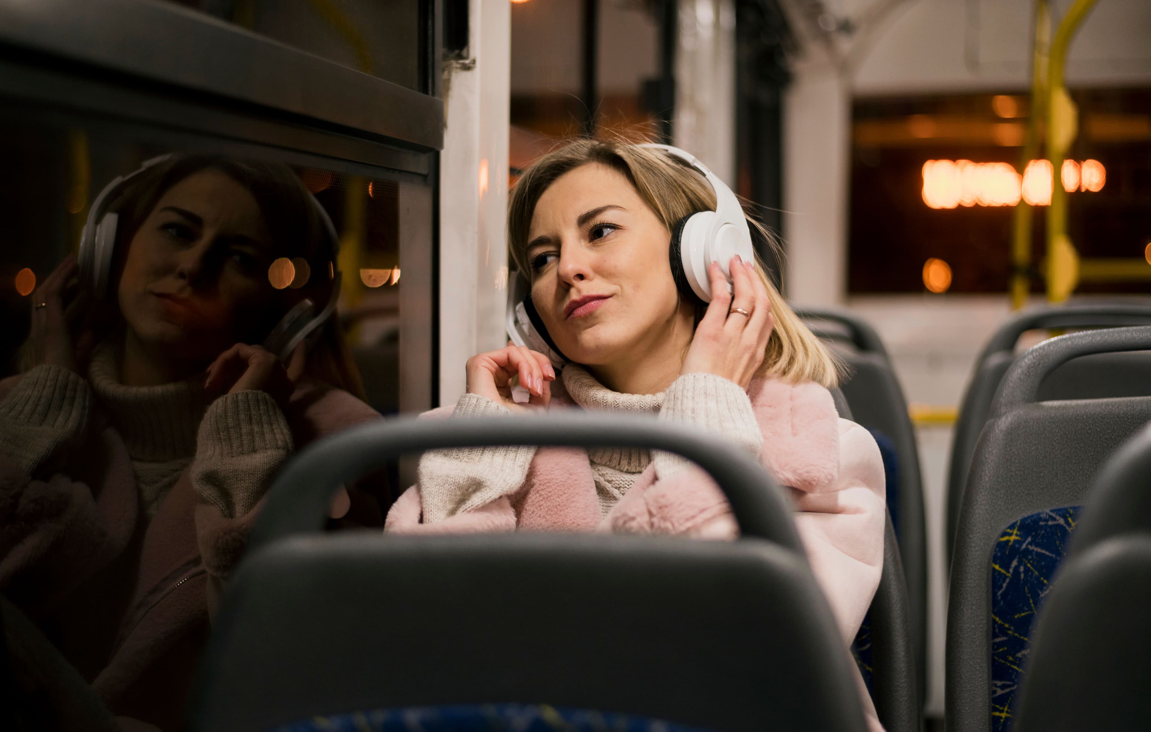 woman-wearing-headphones-sitting-bus.jpg